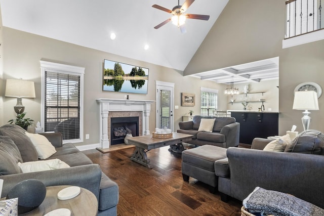 living room featuring ceiling fan, wood finished floors, a fireplace with raised hearth, a chandelier, and recessed lighting