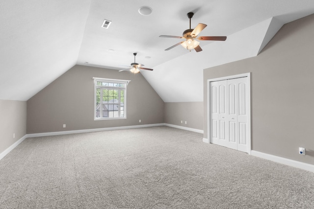additional living space with ceiling fan, vaulted ceiling, carpet floors, and baseboards