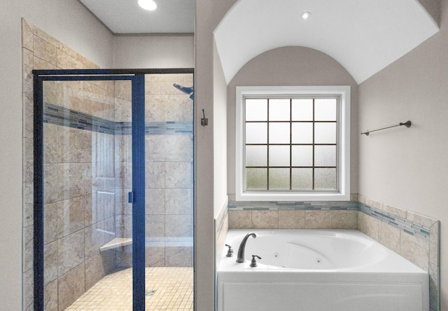 bathroom featuring a tub with jets, a stall shower, and recessed lighting