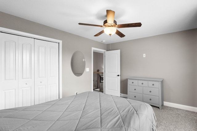 carpeted bedroom with a closet, a ceiling fan, and baseboards