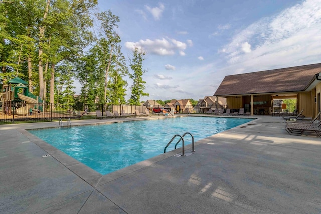 community pool featuring fence and a patio area