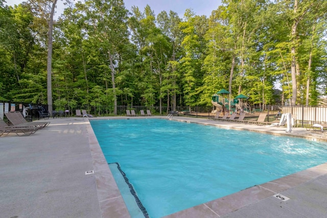 community pool featuring fence and a patio area