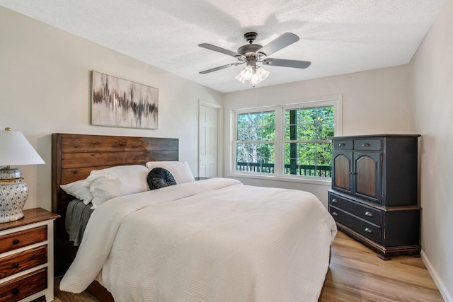 1780 Warren Hollow Rd, Nolensville, TN 37135 - bedroom with light wood-style floors, baseboards, a ceiling fan, and a textured ceiling