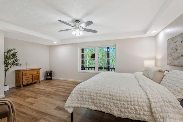 1780 Warren Hollow Rd, Nolensville, TN 37135 - bedroom featuring light wood finished floors, a tray ceiling, baseboards, recessed lighting, and a ceiling fan