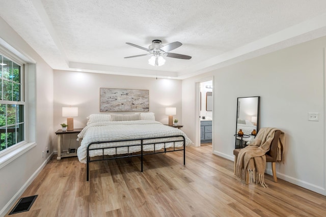 1780 Warren Hollow Rd, Nolensville, TN 37135 - bedroom with a textured ceiling, light wood-style flooring, baseboards, ceiling fan, and ensuite bath
