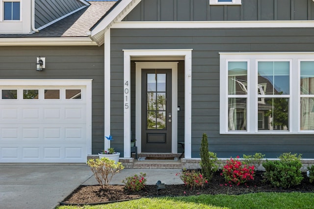 4015 John Marsh Rd, Spring Hill, TN 37174 - doorway to property with a garage, a shingled roof, board and batten siding, and concrete driveway