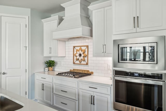 4015 John Marsh Rd, Spring Hill, TN 37174 - kitchen with light countertops, appliances with stainless steel finishes, premium range hood, and decorative backsplash