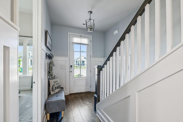 4015 John Marsh Rd, Spring Hill, TN 37174 - entrance foyer with a decorative wall, a chandelier, dark wood finished floors, a wainscoted wall, and stairway