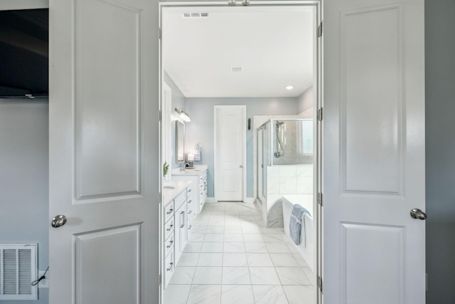 4015 John Marsh Rd, Spring Hill, TN 37174 - full bathroom featuring double vanity, a bath, visible vents, a shower stall, and marble finish floor