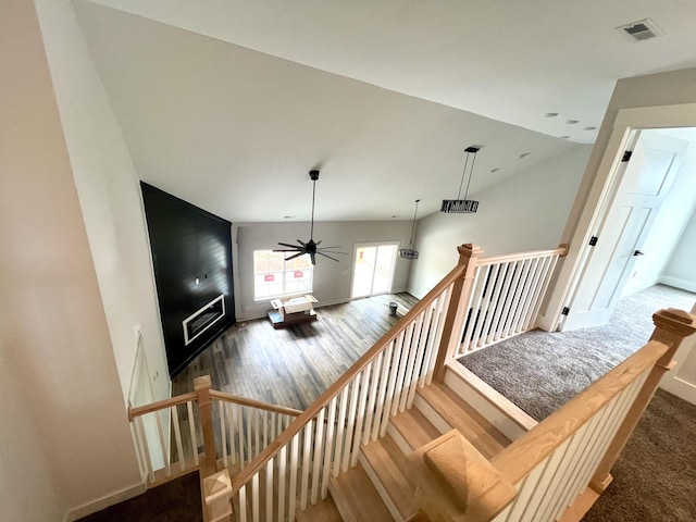 staircase with baseboards, a ceiling fan, wood finished floors, and visible vents
