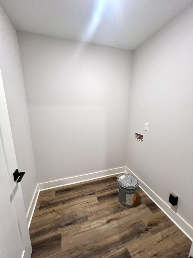 washroom featuring washer hookup, baseboards, laundry area, and wood finished floors
