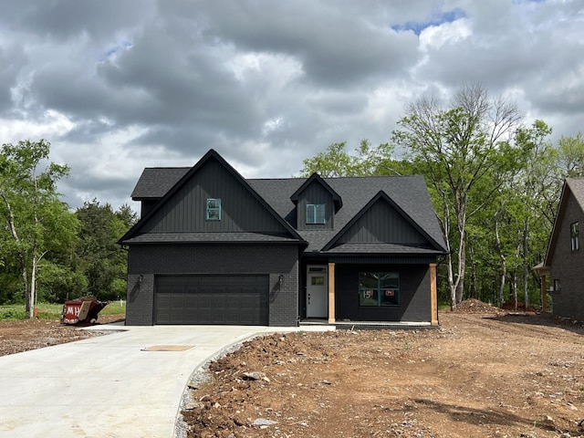 view of front of property featuring a porch, board and batten siding, driveway, brick siding, and a shingled roof