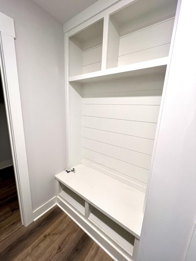 mudroom featuring baseboards and dark wood finished floors