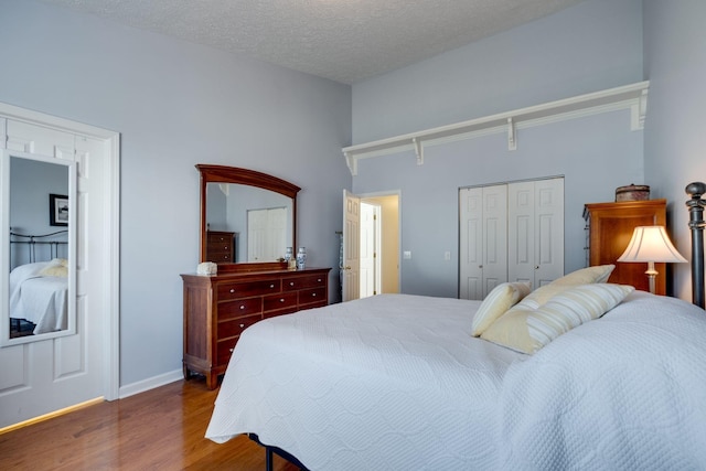 2510 Port Kembla Dr, Mount Juliet, TN 37122 - bedroom featuring a textured ceiling, baseboards, a closet, and wood finished floors