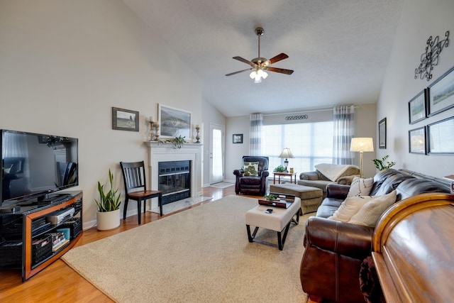 2510 Port Kembla Dr, Mount Juliet, TN 37122 - living room featuring ceiling fan, high vaulted ceiling, baseboards, a glass covered fireplace, and light wood-style flooring