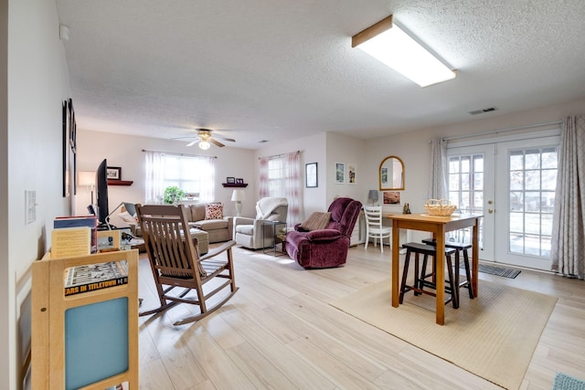 2510 Port Kembla Dr, Mount Juliet, TN 37122 - living area featuring a ceiling fan, a textured ceiling, visible vents, and light wood-style flooring