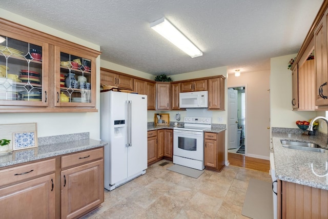 2510 Port Kembla Dr, Mount Juliet, TN 37122 - kitchen featuring white appliances, brown cabinets, glass insert cabinets, and a sink