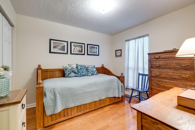 2510 Port Kembla Dr, Mount Juliet, TN 37122 - bedroom featuring light wood-style floors, a closet, and a textured ceiling