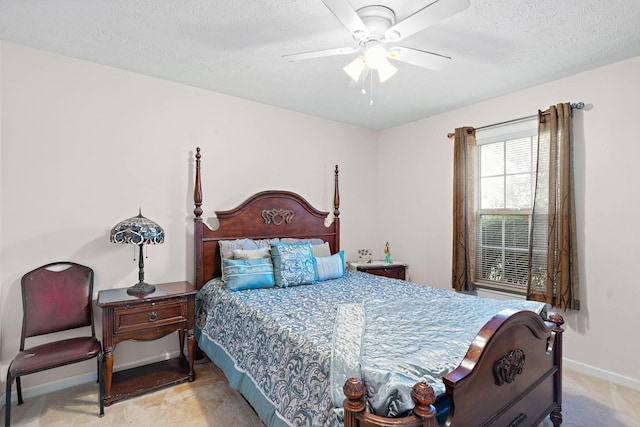 bedroom with baseboards, ceiling fan, carpet flooring, and a textured ceiling