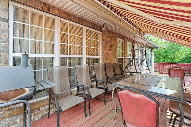 wooden deck featuring outdoor dining area