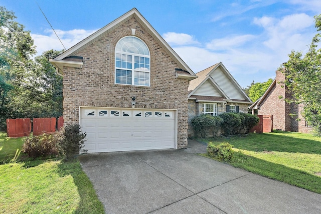 traditional-style house with a front yard, brick siding, fence, concrete driveway, and an attached garage