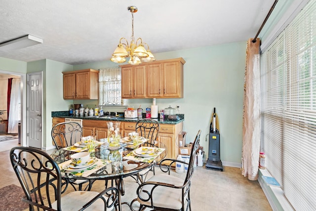 dining area with baseboards and a chandelier