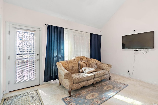sitting room with carpet floors, baseboards, and lofted ceiling
