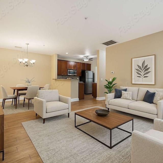7230 Althorp Way Unit 10, Nashville, TN 37211 - living area featuring light wood-type flooring, baseboards, a chandelier, and a ceiling fan