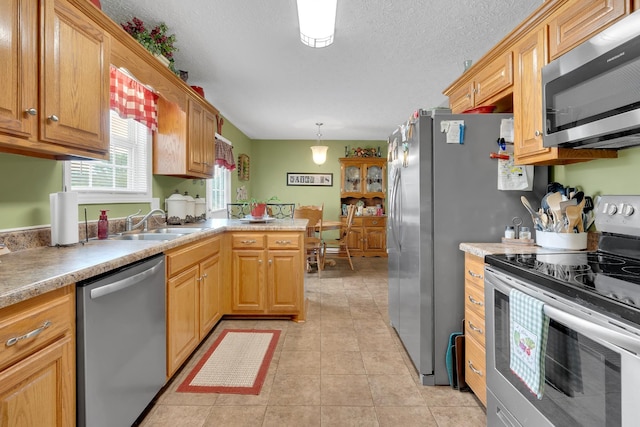 110 Broomsage Cir, Unionville, TN 37180 - kitchen with a sink, light tile patterned floors, light countertops, a peninsula, and stainless steel appliances