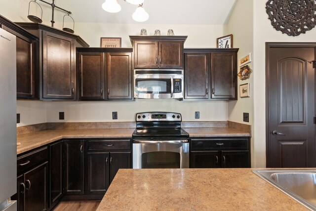 1176 Meachem Dr, Clarksville, TN 37042 - kitchen featuring appliances with stainless steel finishes and dark brown cabinetry
