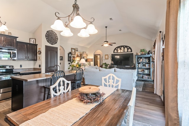 1176 Meachem Dr, Clarksville, TN 37042 - dining area featuring arched walkways, lofted ceiling, a ceiling fan, wood finished floors, and a chandelier