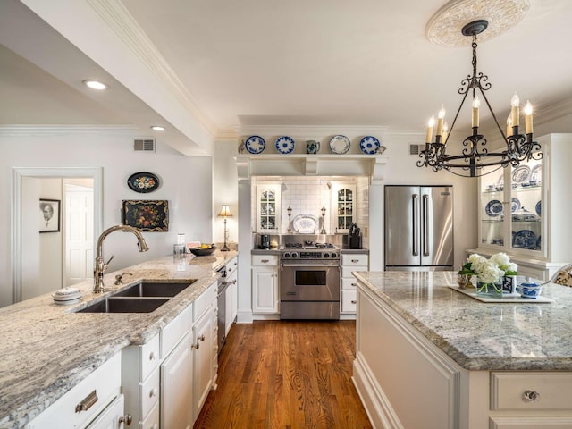 305 Davidson Rd, Nashville, TN 37205 - kitchen with white cabinets, an inviting chandelier, a sink, stainless steel appliances, and visible vents
