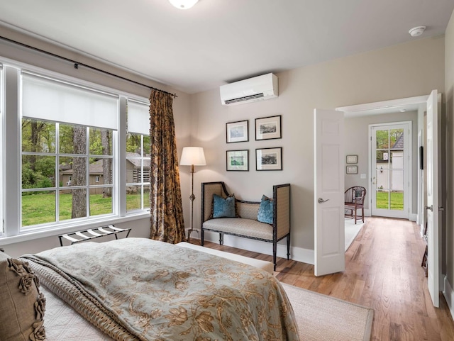 305 Davidson Rd, Nashville, TN 37205 - bedroom featuring baseboards, light wood-style flooring, and a wall mounted air conditioner