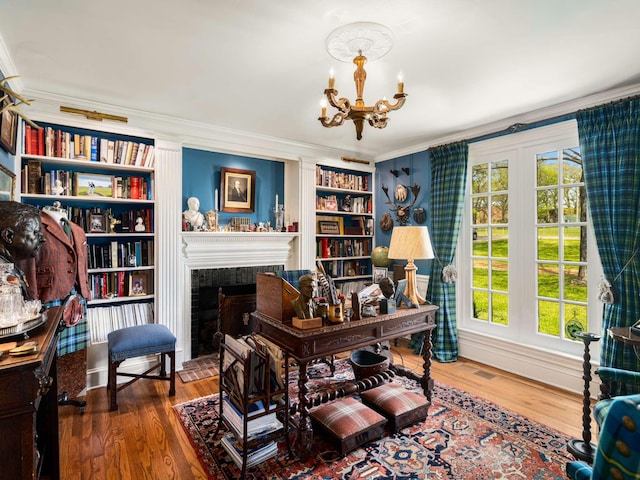 305 Davidson Rd, Nashville, TN 37205 - home office with built in features, wood finished floors, a fireplace with raised hearth, a chandelier, and ornamental molding