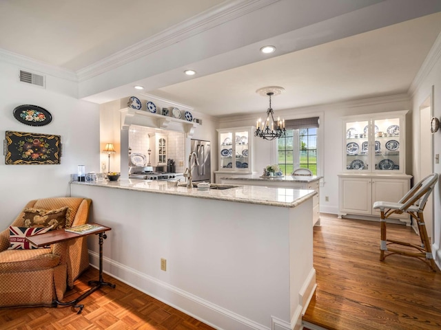 305 Davidson Rd, Nashville, TN 37205 - kitchen with a sink, crown molding, a peninsula, and a chandelier