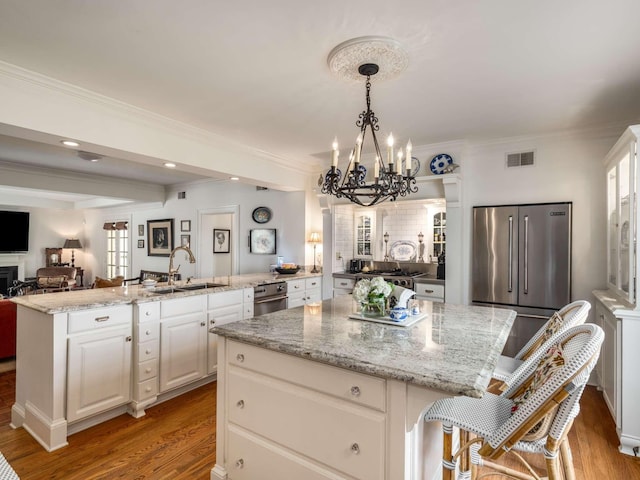 305 Davidson Rd, Nashville, TN 37205 - kitchen featuring visible vents, high end refrigerator, a kitchen island, a chandelier, and a sink