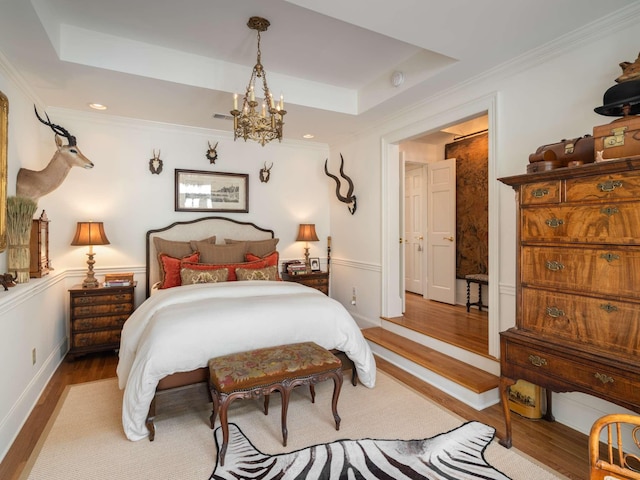 305 Davidson Rd, Nashville, TN 37205 - bedroom featuring an inviting chandelier, ornamental molding, a tray ceiling, and wood finished floors