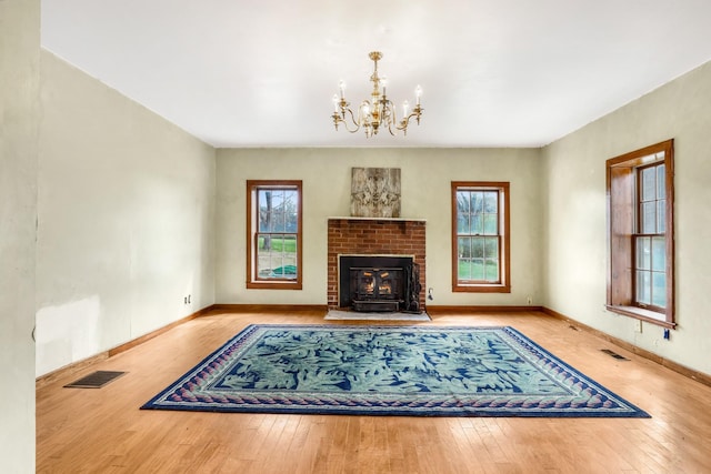 5506 Lickton Pike, Goodlettsville, TN 37072 - living area with wood-type flooring, a notable chandelier, a wealth of natural light, and visible vents