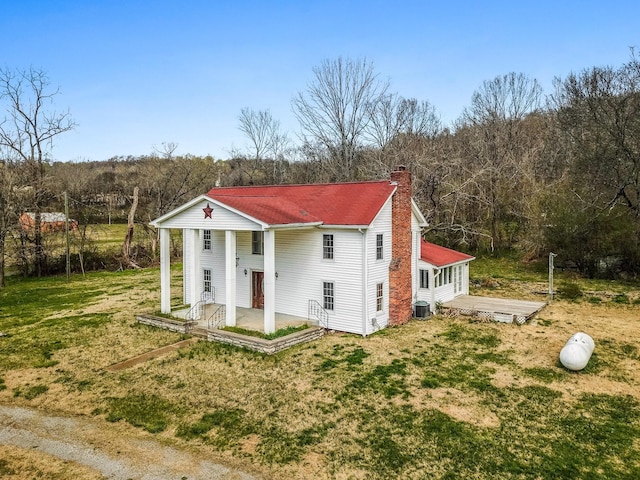 5506 Lickton Pike, Goodlettsville, TN 37072 - view of front of house featuring a front lawn, a patio, a chimney, a view of trees, and central air condition unit