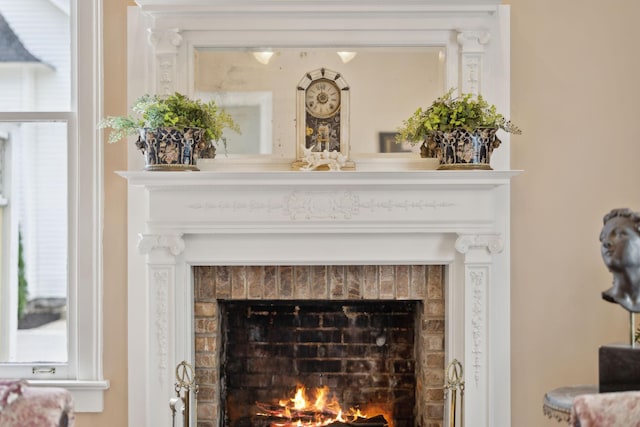 details featuring a warm lit fireplace