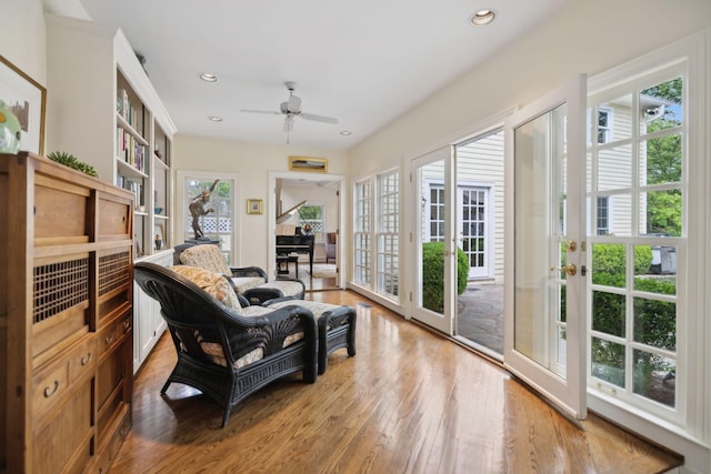 sitting room with ceiling fan, recessed lighting, and wood finished floors