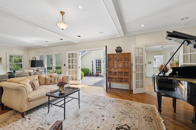 living area with beamed ceiling, french doors, and wood finished floors