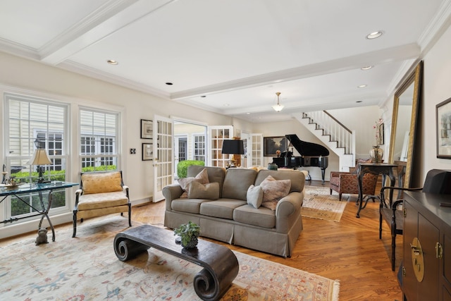 living area with french doors, stairway, beamed ceiling, light wood finished floors, and ornamental molding
