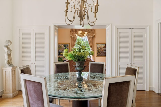 dining space with an inviting chandelier and wood finished floors