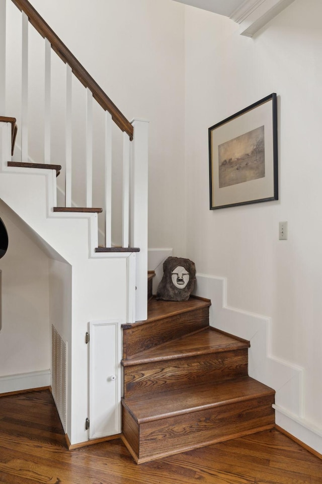 stairs featuring visible vents and wood finished floors