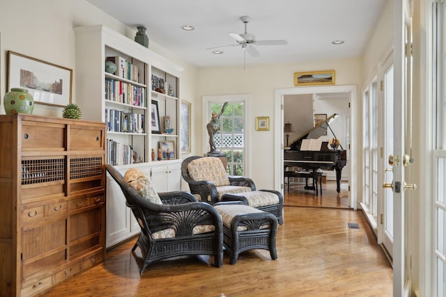 living area featuring a ceiling fan, recessed lighting, light wood-style flooring, and visible vents