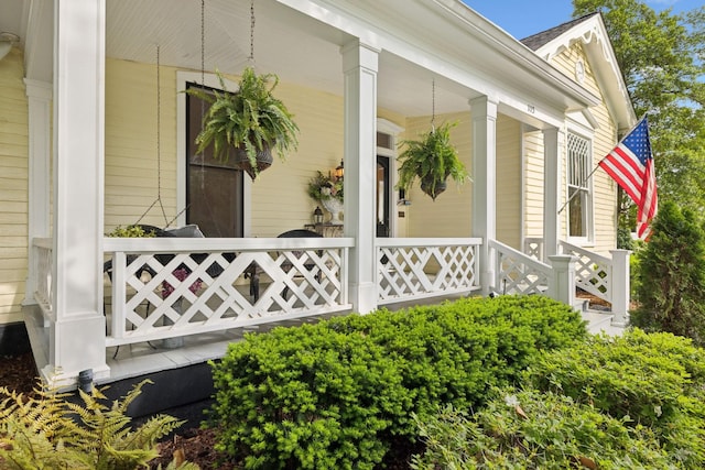 view of side of home featuring covered porch