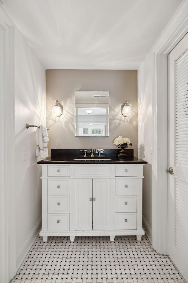 bathroom with baseboards and vanity