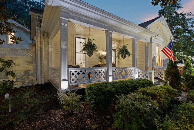 property exterior at dusk with a porch