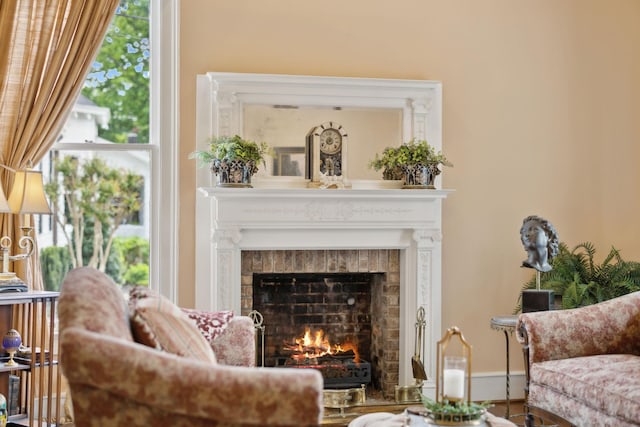 sitting room with a warm lit fireplace